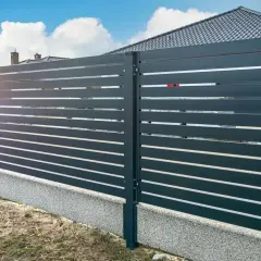 Nowoczesne ogrodzenie z poziomymi deskami, co zamiast podmurówki pod ogrodzenie? Betonowy cokół stanowi estetyczne i trwałe rozwiązanie.